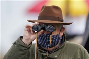 ESHER, ENGLAND - DECEMBER 04: Watching the action through binoculars at Sandown Park on December 04, 2020 in Esher, England. Owners and a limited number of the public are allowed to attend the meeting due to the Coronavirus pandemic. (Photo by Alan Crowhurst/Getty Images)
