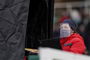 ESHER, ENGLAND - DECEMBER 04: A bookmaker wears a face covering at Sandown Park on December 04, 2020 in Esher, England. Owners and a limited number of the public are allowed to attend the meeting due to the Coronavirus pandemic. (Photo by Alan Crowhurst/Getty Images)