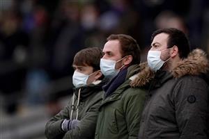 ESHER, ENGLAND - DECEMBER 04: Three racegoers watch the action wearing face masks at Sandown Park on December 04, 2020 in Esher, England. Owners and a limited number of the public are allowed to attend the meeting due to the Coronavirus pandemic. (Photo by Alan Crowhurst/Getty Images)