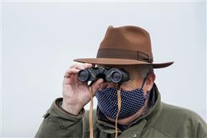 ESHER, ENGLAND - DECEMBER 04: Watching the action through binoculars at Sandown Park on December 04, 2020 in Esher, England. Owners and a limited number of the public are allowed to attend the meeting due to the Coronavirus pandemic. (Photo by Alan Crowhurst/Getty Images)