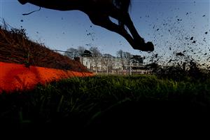 FONTWELL, ENGLAND - DECEMBER 08: A general view as runners clear a fence during The Change Your House With Lumi - Plugin Novices' Handicap Chase at Fontwell Park Racecourse on December 08, 2020 in Fontwell, England. Owners and a limited number of the public are allowed to attend the meeting due to the Coronavirus pandemic. (Photo by Alan Crowhurst/Getty Images)