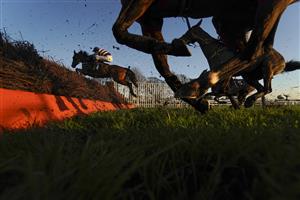 FONTWELL, ENGLAND - DECEMBER 08: A general view as runners clear a fence during The Change Your House With Lumi - Plugin Novices' Handicap Chase at Fontwell Park Racecourse on December 08, 2020 in Fontwell, England. Owners and a limited number of the public are allowed to attend the meeting due to the Coronavirus pandemic. (Photo by Alan Crowhurst/Getty Images)