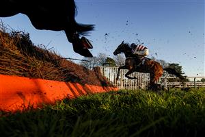 FONTWELL, ENGLAND - DECEMBER 08: A general view as runners clear a fence during The Change Your House With Lumi - Plugin Novices' Handicap Chase at Fontwell Park Racecourse on December 08, 2020 in Fontwell, England. Owners and a limited number of the public are allowed to attend the meeting due to the Coronavirus pandemic. (Photo by Alan Crowhurst/Getty Images)