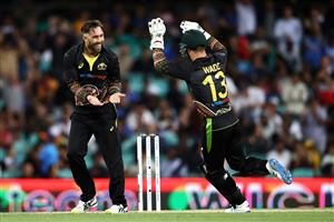 SYDNEY, AUSTRALIA - DECEMBER 08: Glenn Maxwell of Australia celebrates with Matthew Wade of Australia after dismissing KL Rahul of India during game three of the Twenty20 International series between Australia and India at Sydney Cricket Ground on December 08, 2020 in Sydney, Australia. (Photo by Cameron Spencer/Getty Images)