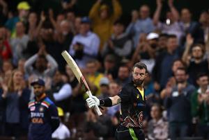 SYDNEY, AUSTRALIA - DECEMBER 08: Matthew Wade of Australia raises his bat as he leaves the ground after being dismissed for 80 runs during game three of the Twenty20 International series between Australia and India at Sydney Cricket Ground on December 08, 2020 in Sydney, Australia. (Photo by Ryan Pierse/Getty Images)