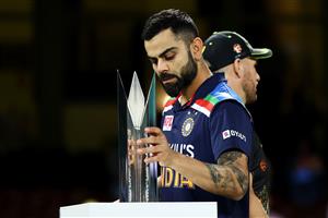 SYDNEY, AUSTRALIA - DECEMBER 08: Virat Kohli of India collects the T20 Trophy following game three of the Twenty20 International series between Australia and India at Sydney Cricket Ground on December 08, 2020 in Sydney, Australia. (Photo by Cameron Spencer/Getty Images)