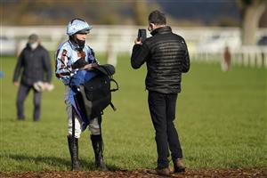 TAUNTON, ENGLAND - DECEMBER 10: Jockey Charlie Hammond does a video for the owners after racing in The Kings College Taunton Selling Hurdle at Taunton Racecourse on December 10, 2020 in Taunton, England. Owners and a limited number of the public are allowed to attend the meeting due to the Coronavirus pandemic. (Photo by Alan Crowhurst/Getty Images)