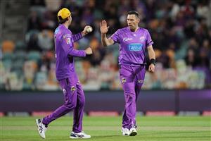 HOBART, AUSTRALIA - DECEMBER 10: Scott Boland of the Hurricanes (R) celebrates with Tim David (L) after taking the wicket of Dan Christian of the Sixers during the Big Bash League match between the Hobart Hurricanes and Sydney Sixers at Blundstone Arena, on December 10, 2020, in Hobart, Australia. (Photo by Matt King/Getty Images)