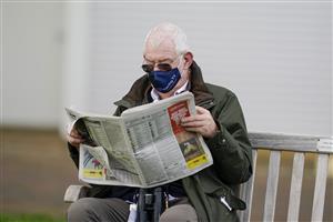 CHELTENHAM, ENGLAND - DECEMBER 11: A racegoer checks the form in the Racing Post at Cheltenham Racecourse on December 11, 2020 in Cheltenham, England. Owners and a limited number of the public are allowed to attend the meeting due to the Coronavirus pandemic. (Photo by Alan Crowhurst/Getty Images)