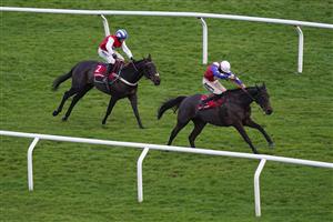 CHELTENHAM, ENGLAND - DECEMBER 11: Sam Twiston-Davies riding Come On Teddy (R) win The Citipost Handicap Hurdle at Cheltenham Racecourse on December 11, 2020 in Cheltenham, England. Owners and a limited number of the public are allowed to attend the meeting due to the Coronavirus pandemic. (Photo by Alan Crowhurst/Getty Images)