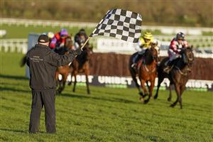 CHELTENHAM, ENGLAND - DECEMBER 12: A general view as a member of the groundstaff waves the chequered flag to show the jockeys to bypass the next hurdle at Cheltenham Racecourse on December 12, 2020 in Cheltenham, England. Owners and a limited number of the public are allowed to attend the meeting due to the Coronavirus pandemic. (Photo by Alan Crowhurst/Getty Images)
