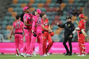 HOBART, AUSTRALIA - DECEMBER 13: Gurinder Sandhu (L) and Daniel Hughes (R) celebrate victory with team mates after the Big Bash League match between the Sydney Sixers and the Melbourne Renegades at Blundstone Arena, on December 13, 2020, in Hobart, Australia. (Photo by Matt King/Getty Images)