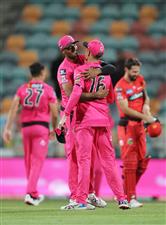 HOBART, AUSTRALIA - DECEMBER 13: Gurinder Sandhu (L) and Daniel Hughes (R) celebrate victory with team mates after the Big Bash League match between the Sydney Sixers and the Melbourne Renegades at Blundstone Arena, on December 13, 2020, in Hobart, Australia. (Photo by Matt King/Getty Images)