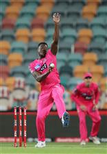 HOBART, AUSTRALIA - DECEMBER 13: Carlos Brathwaite of the Sixers bowls during the Big Bash League match between the Sydney Sixers and the Melbourne Renegades at Blundstone Arena, on December 13, 2020, in Hobart, Australia. (Photo by Matt King/Getty Images)