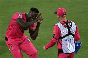 HOBART, AUSTRALIA - DECEMBER 13: Carlos Brathwaite of the Sixers celebrates taking the wicket of Jake Fraser-McGurk of the Renegades during the Big Bash League match between the Sydney Sixers and the Melbourne Renegades at Blundstone Arena, on December 13, 2020, in Hobart, Australia. (Photo by Steve Bell/Getty Images)
