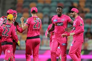 HOBART, AUSTRALIA - DECEMBER 13: Carlos Brathwaite of the Sixers celebrates with team mates after taking the wicket of Benny Howell of the Renegades during the Big Bash League match between the Sydney Sixers and the Melbourne Renegades at Blundstone Arena, on December 13, 2020, in Hobart, Australia. (Photo by Matt King/Getty Images)