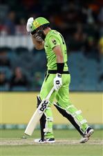 CANBERRA, AUSTRALIA - DECEMBER 14: Alex Ross of the Thunder
walks from the field after being dismissed by Matthew Kuhnemann of the Heat during the Big Bash League match between the Sydney Thunder and the Brisbane Heat at Manuka Oval, on December 14, 2020, in Canberra, Australia. (Photo by Brendon Thorne/Getty Images)