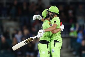 CANBERRA, AUSTRALIA - DECEMBER 14: Daniel Sams and Chris Green of the Thunder celebrate victory over the Heat during the Big Bash League match between the Sydney Thunder and the Brisbane Heat at Manuka Oval, on December 14, 2020, in Canberra, Australia. (Photo by Brendon Thorne/Getty Images)