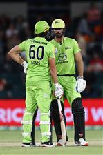 CANBERRA, AUSTRALIA - DECEMBER 14: Daniel Sams and Ben Cutting of the Thunder chat during the Big Bash League match between the Sydney Thunder and the Brisbane Heat at Manuka Oval, on December 14, 2020, in Canberra, Australia. (Photo by Brendon Thorne/Getty Images)