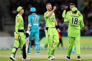 CANBERRA, AUSTRALIA - DECEMBER 14: Nathan McAndrew of the Thunder celebrates with team mates after claiming the wicket of Tom Cooper of the Heat during the Big Bash League match between the Sydney Thunder and the Brisbane Heat at Manuka Oval, on December 14, 2020, in Canberra, Australia. (Photo by Brendon Thorne/Getty Images)