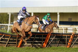 WINCANTON, ENGLAND - DECEMBER 15: Matt Griffiths riding Sizable Sam (silver) clear the last to win The Watch On Racing TV Novices' Hurdle at Wincanton Racecourse on December 15, 2020 in Wincanton, England. Owners and a limited number of the public are allowed to attend the meeting due to the Coronavirus pandemic. (Photo by Alan Crowhurst/Getty Images)
