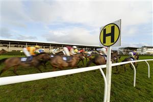 WINCANTON, ENGLAND - DECEMBER 15: A general view as runners pass the grandstands in The Racing TV HD On Sky 426 Mares' Handicap Hurdle at Wincanton Racecourse on December 15, 2020 in Wincanton, England. Owners and a limited number of the public are allowed to attend the meeting due to the Coronavirus pandemic. (Photo by Alan Crowhurst/Getty Images)