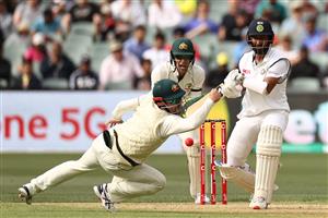 ADELAIDE, AUSTRALIA - DECEMBER 17: Travis Head of Australia attempts to catch out Cheteshwar Pujara of India during day one of the First Test match between Australia and India at Adelaide Oval on December 17, 2020 in Adelaide, Australia. (Photo by Ryan Pierse/Getty Images)