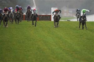 ASCOT, ENGLAND - DECEMBER 18: Joe Anderson riding Emir Sacree (green) clear the last to win The ITV7 100k Jackpot On Boxing Day Conditional Jockeys' Handicap Hurdle at Ascot Racecourse on December 18, 2020 in Ascot, England. Owners are allowed to attend if they have a runner at the meeting otherwise racing remains behind closed doors to the public due to the Coronavirus pandemic. (Photo by Alan Crowhurst/Getty Images)