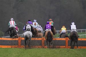 ASCOT, ENGLAND - DECEMBER 18: A general view as runners in The ITV7 100k Jackpot On Boxing Day Conditional Jockeys' Handicap Hurdle take a hurdle down the side of the rack at Ascot Racecourse on December 18, 2020 in Ascot, England. Owners are allowed to attend if they have a runner at the meeting otherwise racing remains behind closed doors to the public due to the Coronavirus pandemic. (Photo by Alan Crowhurst/Getty Images)