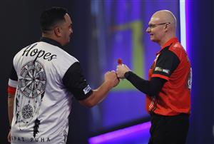 LONDON, ENGLAND - DECEMBER 18: Mickey Mansell of Northern Ireland (R) and Haupai Puha of New Zealand congratulate each other after there first round match during day four of the PDC William Hill World Darts Championship at Alexandra Palace on December 18, 2020 in London, England. (Photo by Luke Walker/Getty Images)