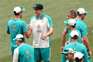 ADELAIDE, AUSTRALIA - DECEMBER 17: Mitchell Starc of Australia congratulates Cameron Green of Australia on his test debut after receiving his Test Cap during day one of the First Test match between Australia and India at Adelaide Oval on December 17, 2020 in Adelaide, Australia. (Photo by Cameron Spencer/Getty Images)