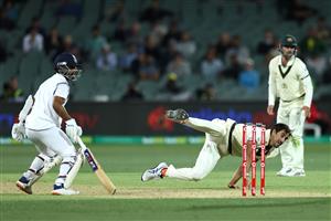 ADELAIDE, AUSTRALIA - DECEMBER 17: Mitchell Starc of Australia fields his own delivery during day one of the First Test match between Australia and India at Adelaide Oval on December 17, 2020 in Adelaide, Australia. (Photo by Cameron Spencer/Getty Images)