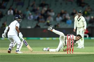 ADELAIDE, AUSTRALIA - DECEMBER 17: Mitchell Starc of Australia fields his own delivery during day one of the First Test match between Australia and India at Adelaide Oval on December 17, 2020 in Adelaide, Australia. (Photo by Cameron Spencer/Getty Images)