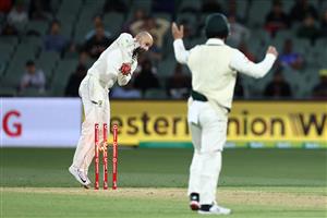 ADELAIDE, AUSTRALIA - DECEMBER 17: Nathan Lyon of Australia knocks the bails off the stumps after a throw from Josh Hazlewood of Australia to dismiss Virat Kohli of India for 74 runs during day one of the First Test match between Australia and India at Adelaide Oval on December 17, 2020 in Adelaide, Australia. (Photo by Ryan Pierse/Getty Images)