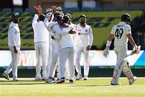 ADELAIDE, AUSTRALIA - DECEMBER 18: Steve Smith of Australia looks dejected as the India players celebrate after he was dismissed by Ravi Ashwin of India during day two of the First Test match between Australia and India at Adelaide Oval on December 18, 2020 in Adelaide, Australia. (Photo by Ryan Pierse/Getty Images)