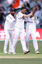 ADELAIDE, AUSTRALIA - DECEMBER 18: Umesh Yadav of India celebrates with his team mates after taking the wicket of Marnus Labuschagne of Australia during day two of the First Test match between Australia and India at Adelaide Oval on December 18, 2020 in Adelaide, Australia. (Photo by Ryan Pierse/Getty Images)