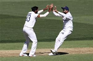 ADELAIDE, AUSTRALIA - DECEMBER 18: Jasprit Bumrah of India celebrates with Virat Kohli of India after dismissing Joe Burns of Australia for lbw during day two of the First Test match between Australia and India at Adelaide Oval on December 18, 2020 in Adelaide, Australia. (Photo by Ryan Pierse/Getty Images)