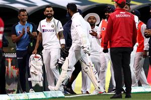 ADELAIDE, AUSTRALIA - DECEMBER 18: Virat Kohli and Jasprit Bumrah of India share a laugh as Bumrah leaves the field not out at the the end of play during day two of the First Test match between Australia and India at Adelaide Oval on December 18, 2020 in Adelaide, Australia. (Photo by Ryan Pierse/Getty Images)