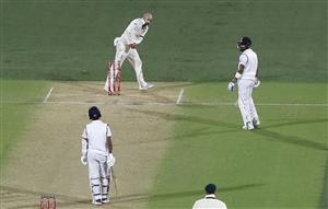 ADELAIDE, AUSTRALIA - DECEMBER 17: Nathan Lyon of Australia knocks the bails off the stumps after a throw from Josh Hazlewood of Australia to dismiss Virat Kohli of India for 74 runs during day one of the First Test match between Australia and India at Adelaide Oval on December 17, 2020 in Adelaide, Australia. (Photo by Ryan Pierse/Getty Images)