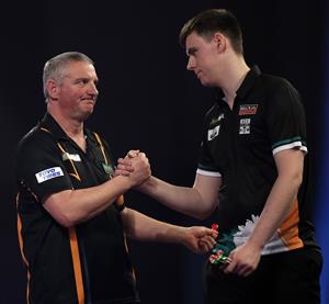 LONDON, ENGLAND - DECEMBER 18: Wayne Jones of England (L) and Ciarán Teehan of Ireland congratulate each other during there first round match during day four of the PDC William Hill World Darts Championship at Alexandra Palace on December 18, 2020 in London, England. (Photo by Luke Walker/Getty Images)