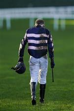 ASCOT, ENGLAND - DECEMBER 19: A muddy Joshua Moore makes his return after falling from his mount during The 'For The Love Of Racing' Handicap Chase at Ascot Racecourse on December 19, 2020 in Ascot, England. Owners are allowed to attend if they have a runner at the meeting otherwise racing remains behind closed doors to the public due to the Coronavirus pandemic. (Photo by Alan Crowhurst/Getty Images)
