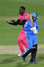 HOBART, AUSTRALIA - DECEMBER 20: Carlos Brathwaite of the Sixers celebrates taking the wicket of Rashid Khan of the Strikers during the Big Bash League match between the Sydney Sixers and the Adelaide Strikers at Blundstone Arena, on December 20, 2020, in Hobart, Australia. (Photo by Steve Bell/Getty Images)