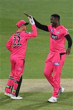 HOBART, AUSTRALIA - DECEMBER 20: Carlos Brathwaite of the Sixers celebrates taking the wicket of Rashid Khan of the Strikers during the Big Bash League match between the Sydney Sixers and the Adelaide Strikers at Blundstone Arena, on December 20, 2020, in Hobart, Australia. (Photo by Steve Bell/Getty Images)