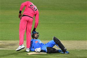 HOBART, AUSTRALIA - DECEMBER 20: Carlos Brathwaite of the Sixers checks on Jon Wells of the Strikers during the Big Bash League match between the Sydney Sixers and the Adelaide Strikers at Blundstone Arena, on December 20, 2020, in Hobart, Australia. (Photo by Steve Bell/Getty Images)