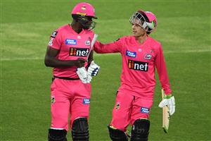 HOBART, AUSTRALIA - DECEMBER 20: Daniel Hughes of the Sixers and Jason Holder of the Sixers leave the field after the innings during the Big Bash League match between the Sydney Sixers and the Adelaide Strikers at Blundstone Arena, on December 20, 2020, in Hobart, Australia. (Photo by Steve Bell/Getty Images)