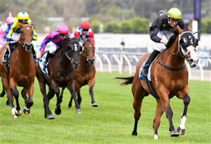 MELBOURNE, AUSTRALIA - DECEMBER 19: Jockey Campbell Rawiller riding Defiant Dancer to win Race 7, the Furphy Festive Season Sprint, during Melbourne Racing at Flemington Racecourse on December 19, 2020 in Melbourne, Australia. (Photo by Vince Caligiuri/Getty Images)
