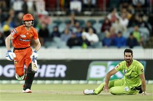 CANBERRA, AUSTRALIA - DECEMBER 22: Cameron Bancroft of the Perth Scorchers takes a run as Ben Cutting of the Thunder slips over during the Big Bash League match between the Sydney Thunder and the Perth Scorchers at Manuka Oval, on December 22, 2020, in Canberra, Australia. (Photo by Darrian Traynor/Getty Images)