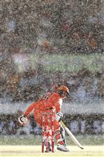 CANBERRA, AUSTRALIA - DECEMBER 22: Colin Munro of the Scorches touches his bat down for a run in the rain during the Big Bash League match between the Sydney Thunder and the Perth Scorchers at Manuka Oval, on December 22, 2020, in Canberra, Australia. (Photo by Darrian Traynor/Getty Images)
