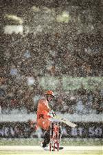 CANBERRA, AUSTRALIA - DECEMBER 22: Colin Munro of the Scorches touches his bat down for a run in the rain during the Big Bash League match between the Sydney Thunder and the Perth Scorchers at Manuka Oval, on December 22, 2020, in Canberra, Australia. (Photo by Darrian Traynor/Getty Images)