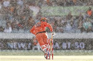 CANBERRA, AUSTRALIA - DECEMBER 22: Colin Munro of the Scorches touches his bat down for a run in the rain during the Big Bash League match between the Sydney Thunder and the Perth Scorchers at Manuka Oval, on December 22, 2020, in Canberra, Australia. (Photo by Darrian Traynor/Getty Images)